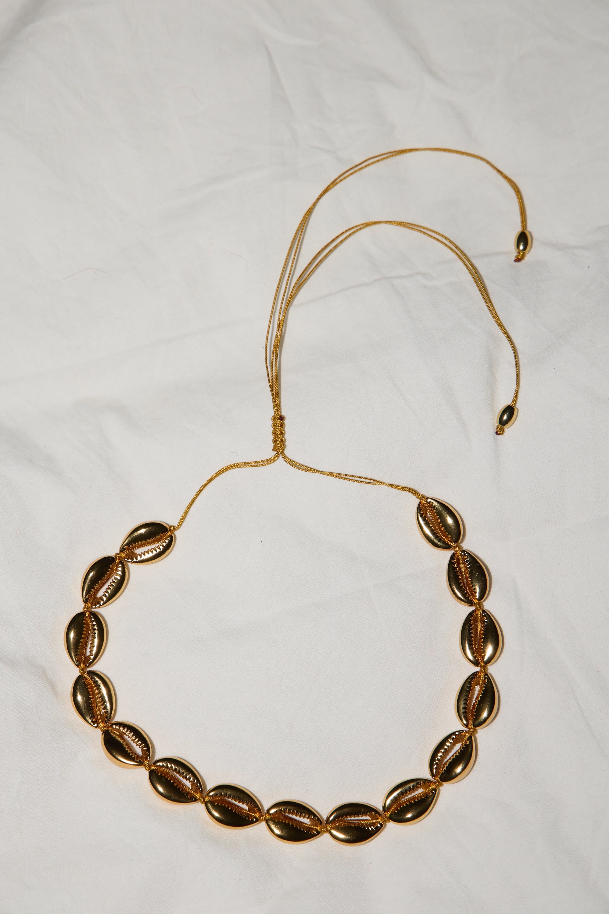 The Large Puka Shell Necklace in Gold by Tohum