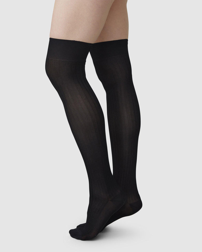 Black ribbed over-knee Ella socks by Swedish Stockings from Blackbird Collection's sustainable accessories