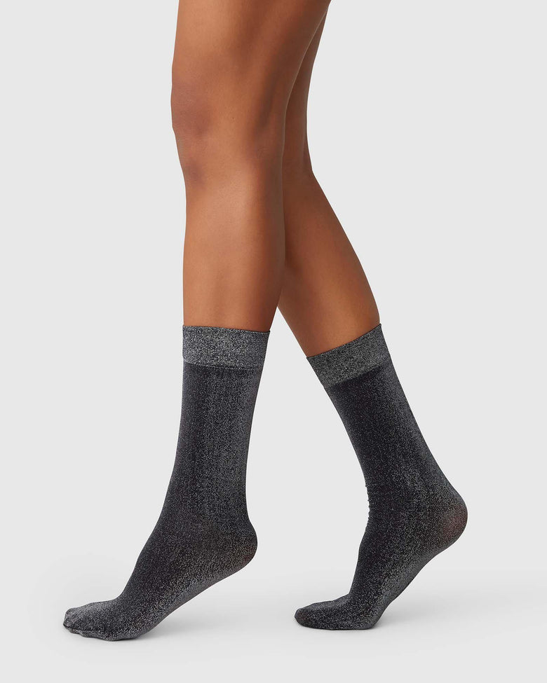Ines semi-sheer shimmery socks in black by Swedish Stockings from Blackbird Collection's sustainable accessories