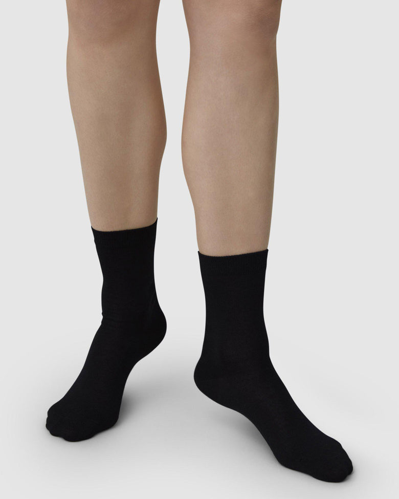 Black organic wool socks by Swedish Stockings from Blackbird Collection's sustainable accessories