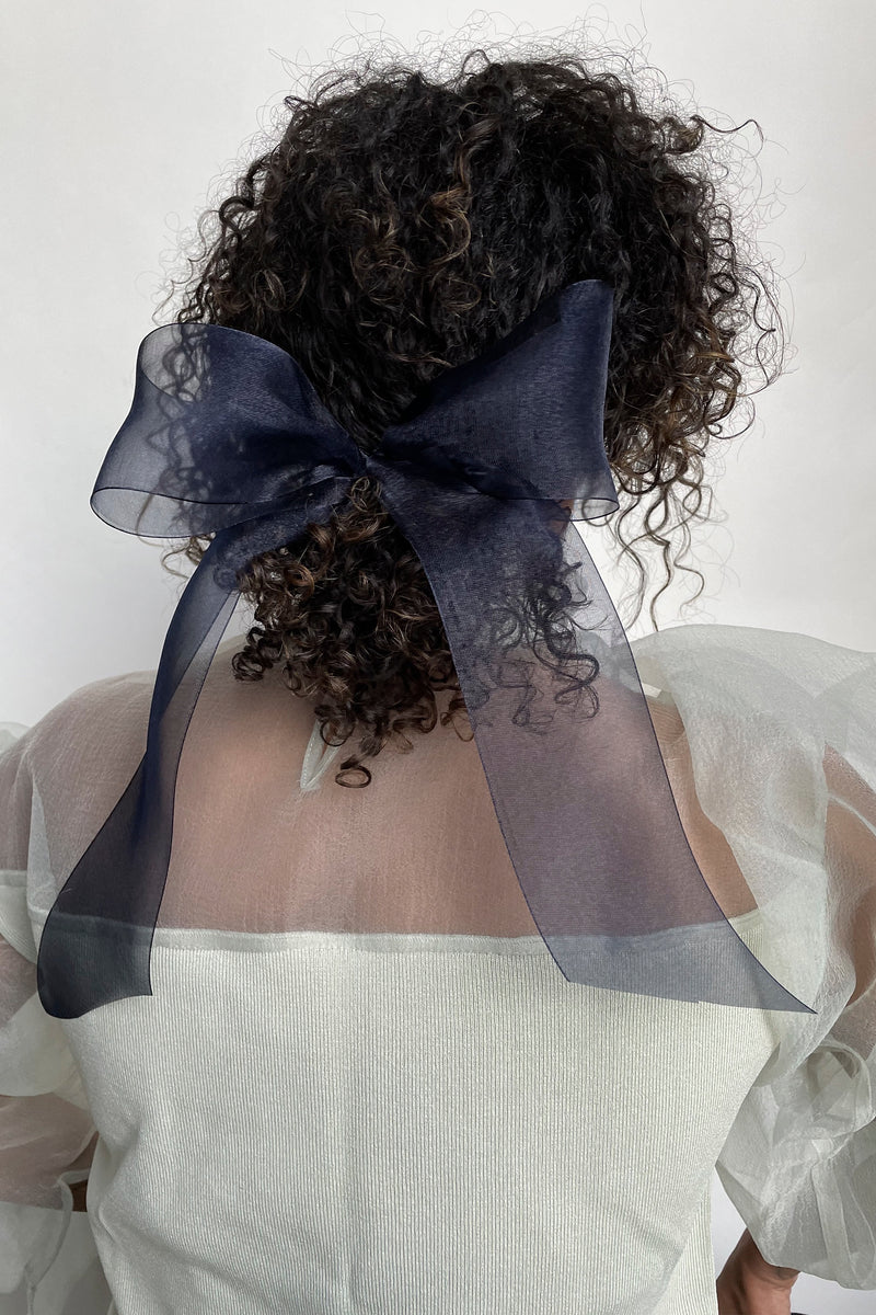 Black sheer bow barrette by Lelet from Blackbird Collection's sustainable hair accessories on model