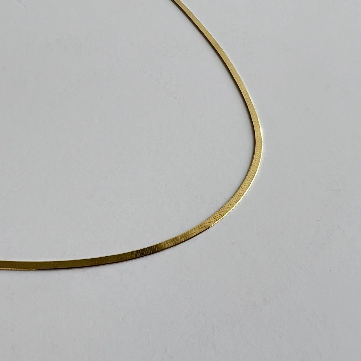 Thin herringbone necklace in gold by Enti Ana from Blackbird Collection's sustainable accessories and jewelry, minimalist layering necklace