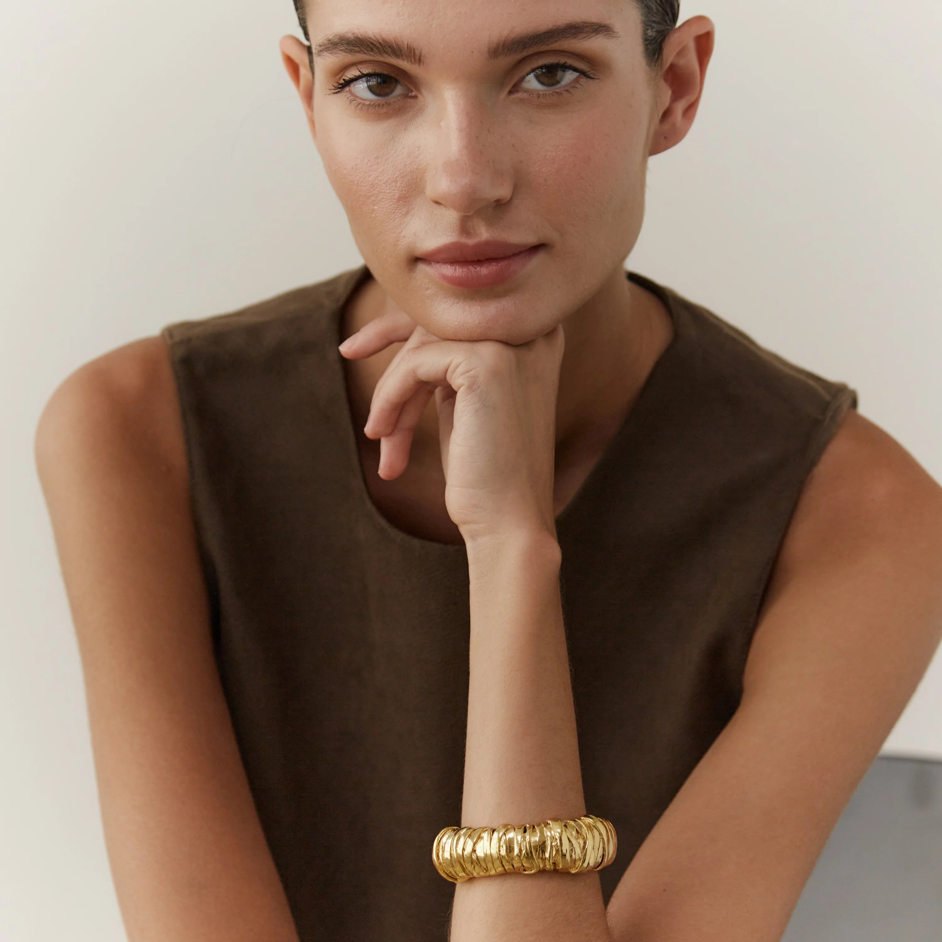 Wrap bracelet in gold on model by Paola Sighinolfi from Blackbird Collection's sustainable accessories and jewelry