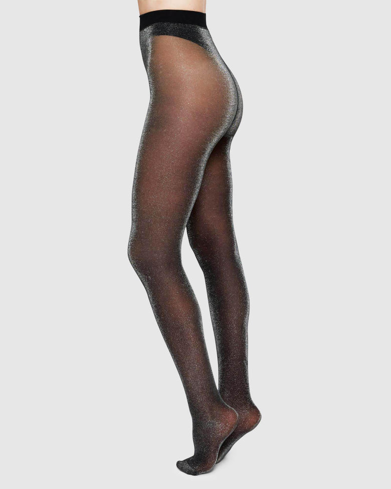 Tora shimmery sheer tights in black by Swedish Stockings from Blackbird Collection's sustainable accessories